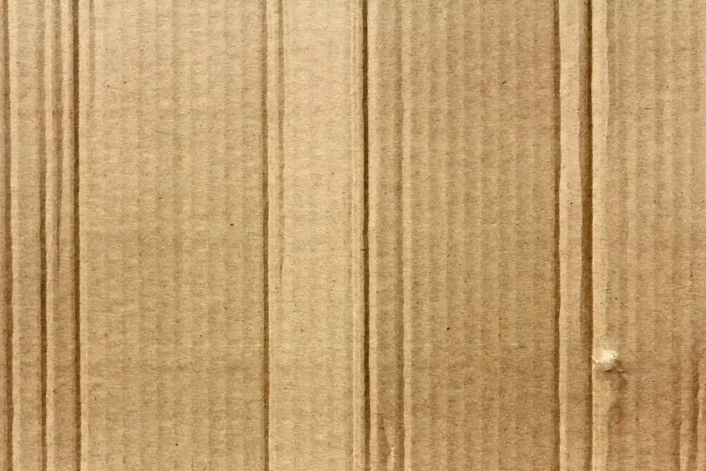 Brown corrugated cardboard surface with a ridged texture