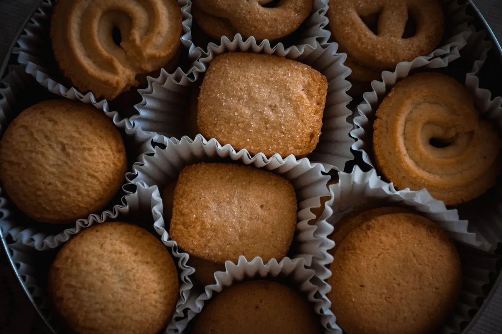 Assorted butter cookies packed side by side in a round gift tin
