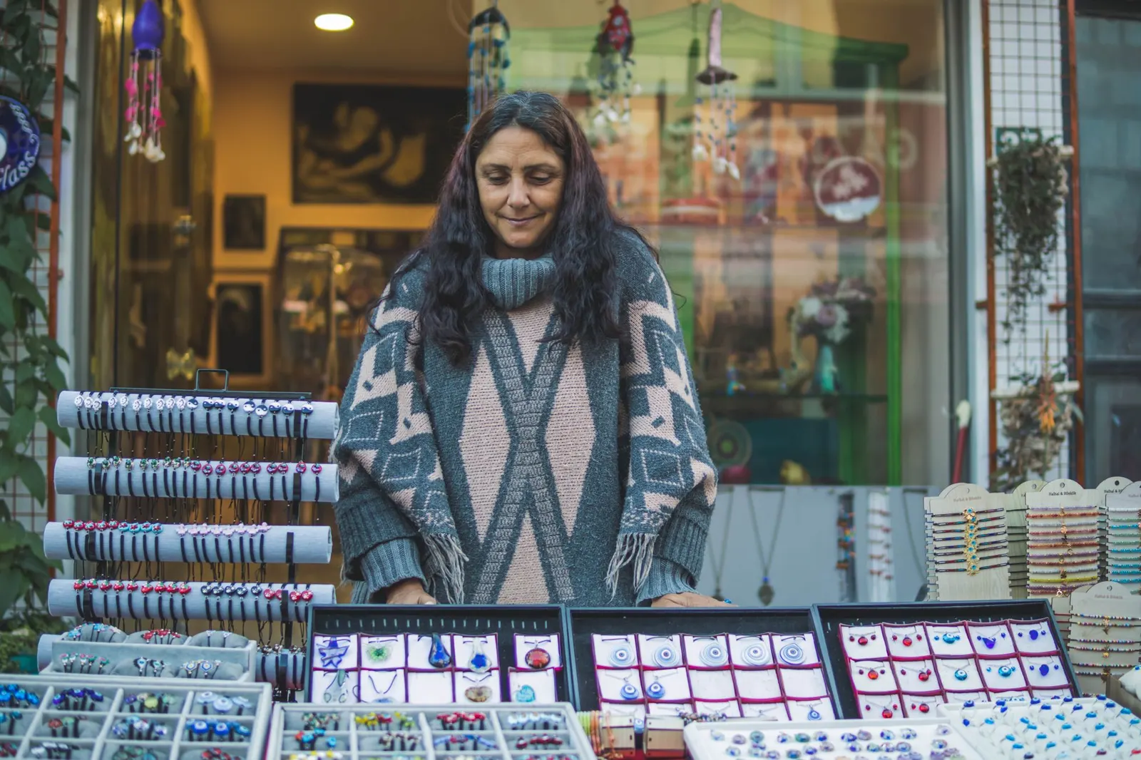Handmade jewelry laid out on a market stall table